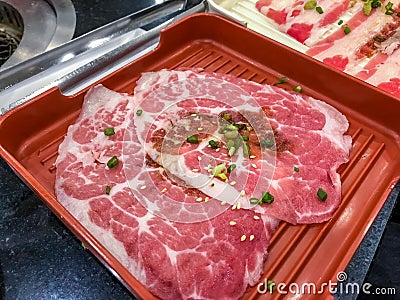 Close up. Slide raw wagyu beef on a red and white plate. uncooked beef, Japanese style for meat grill. Stock Photo