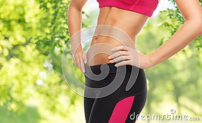 Close up of slim fit woman`s body with trained abs Stock Photo