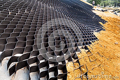 Close up of slope erosion control with grids and earth on steep slope Stock Photo