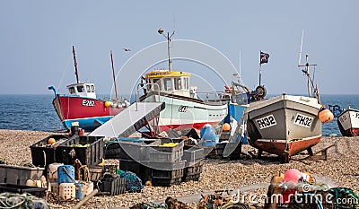 Close up of small fishing boats moored by beaching on shingle beach at Beer in Devon, UK Editorial Stock Photo