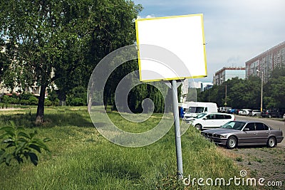 Close-up of small street billboard with empty blank, near public car parking Stock Photo