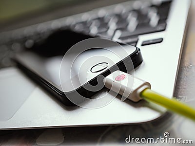 Close-up of smartphone charging Stock Photo