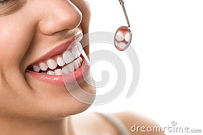 Close-up of smile patient with healthy tooth with dental mirror Stock Photo