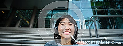 Close up of smiling asian girl feels inspired while draws on digital tablet, makes graphic design project, pencils user Stock Photo