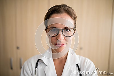 Close-up of smiling female practitioner wearing eyeglasses Stock Photo
