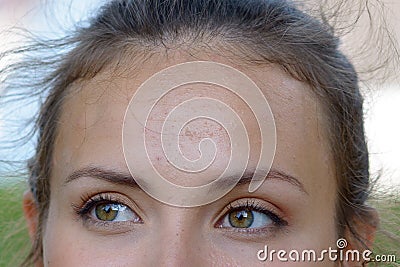 Close up the smiling green eyes of a young woman Stock Photo