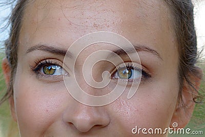 Close up the smiling green eyes of a young woman Stock Photo