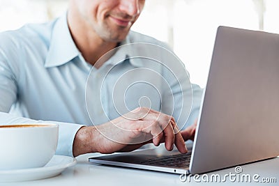 Close up of a smiling mature man using laptop computer Stock Photo