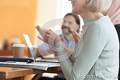 Close up smiling middle aged business woman clapping hands. Stock Photo