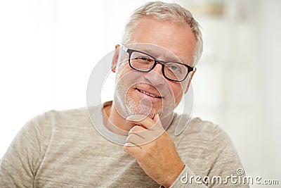 Close up of smiling senior man in glasses thinking Stock Photo