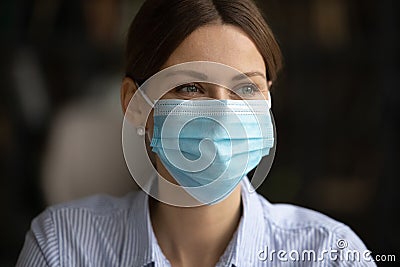 Smiling woman in facial mask protect from covid-19 Stock Photo