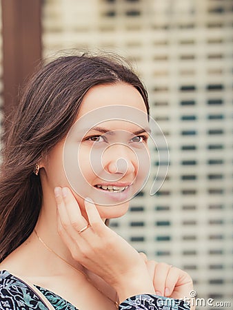 Close up of smiling young woman looking away. Vertical portraite Stock Photo