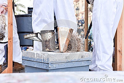 Close-up of smoker with lid open over a beehive. Stock Photo