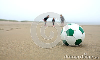 Close up of soccer ball with three people Stock Photo