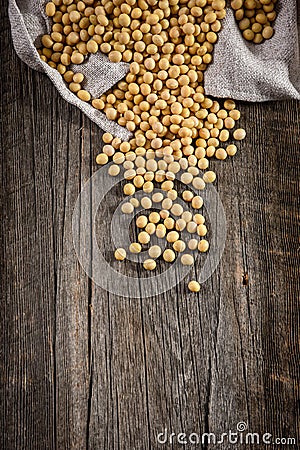 Close-up of soybean on wood background in jute sack. Stock Photo