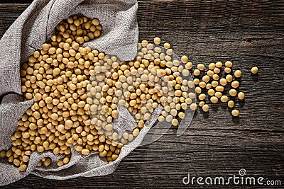 Close-up of soybean on wood background in jute sack. Stock Photo