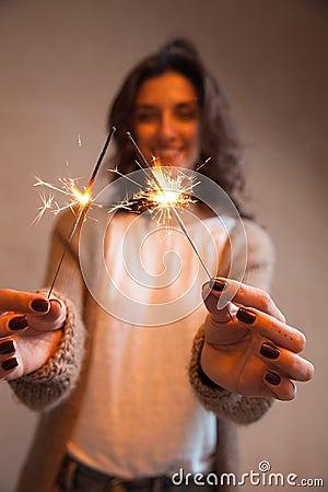 Close-up of sparkler in in woman hands Stock Photo