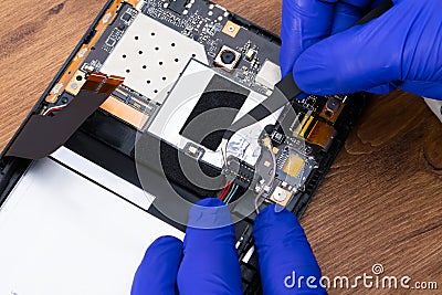 close-up of a specialist's work on replacing an electronic board and disconnecting contacts for a new one, repair Stock Photo