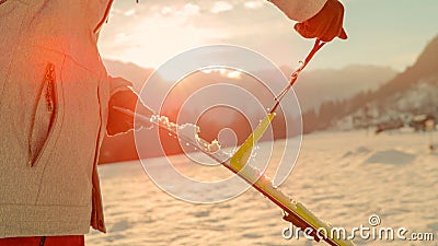 CLOSE UP: Split boarder takes the protective layer off the bottom of skis. Stock Photo