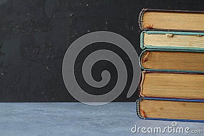 Close-up of stack of old used books background. Pile of vintage old hardback books. Back to school. Copy space Stock Photo