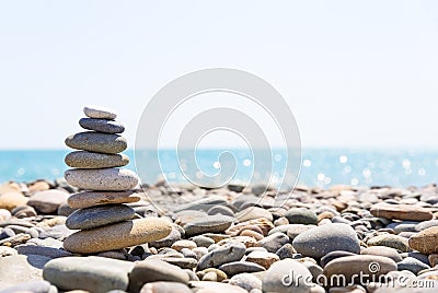 Close-up of stack of stones in perfect balance on a beautiful sunny beach Stock Photo