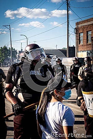 Close up of state patrol police officer standing guard towards black lives matter protestors at minneapolis riots Editorial Stock Photo