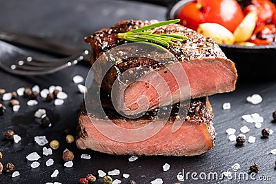 Close-up of steak Top Blade roasting medium ready to eat on dark stone background Stock Photo