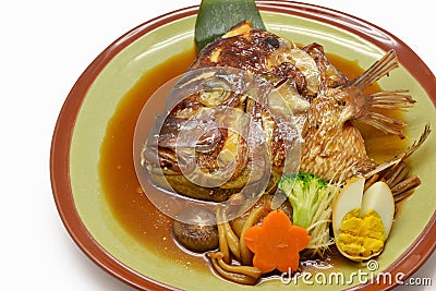 Close-up steamed salmon Head with soy sauce in green plate Japan Stock Photo