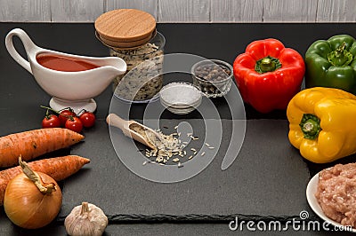 Close up. Cooking dinner at home. Ingredients for roasting stuffed bell peppers. Black background Stock Photo