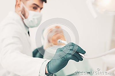 Close up of stomatologist taking dental drill Stock Photo