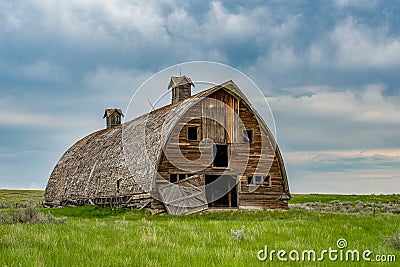 Close up of a stormy skies over an old abandoned prairie barn in rural Saskatchewan Stock Photo