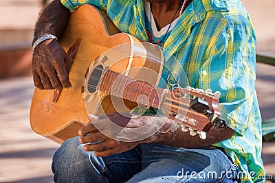 Close up of a street musician playing a guitar in Trinidad Cuba Stock Photo