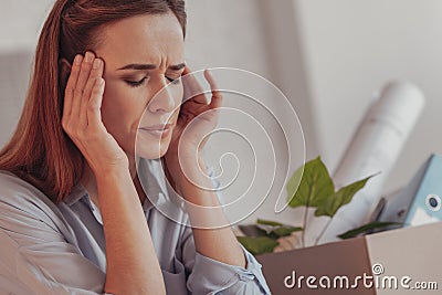 Close up of stressed woman touching her temples Stock Photo