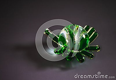 Close up striped glass souvenir figurine on a dark background. Stock Photo