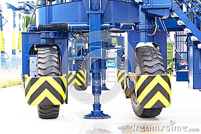Close Up structure Wheel Rubber big size Tried Gantry Cranes (RTG) At Industrial Port moving in position other. Stock Photo