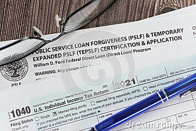Close up of student Loan Forgiveness application with tax info and glasses. Editorial Stock Photo