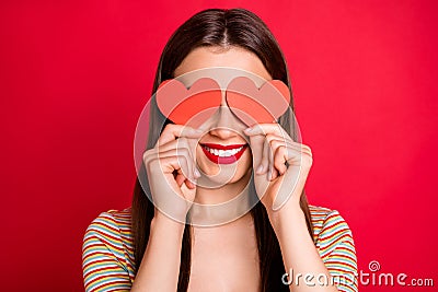 Close-up studio photo portrait of pretty charming lady with toothy beaming smile holding two small paper cards in hands Stock Photo