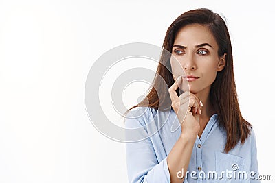 Close-up studio shot curious, serious-looking businesswoman pondering important business choice, look sideways copy Stock Photo