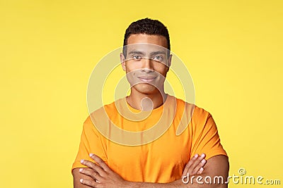Close-up studio shot smiling, cheerful and strong young athlete male in casual t-shirt, cross arms chest self-assured Stock Photo