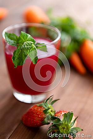 Closeup studio shot two glasses of freshly blended squeezed decorated with strawberry and carrot healthy diet vegan drink fresh Stock Photo