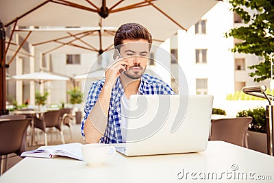 Close up of stylish freelancer, working on his computer and talk Stock Photo