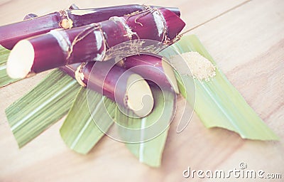 Close up sugar cane on rustic wood table.Brown sugar and cane on wood background.Cane top view.Cane . Stock Photo