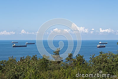 Close-up of the summer landscape. Blue sea, clouds over the horizon and cargo ships Stock Photo