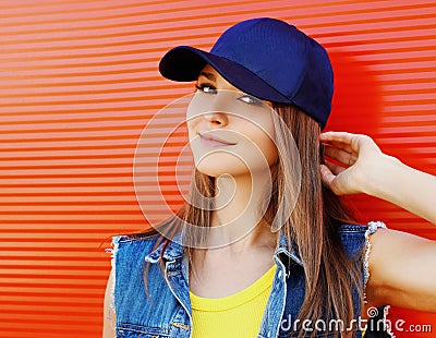 Close up summer portrait of attractive young woman wearing a blue baseball cap Stock Photo