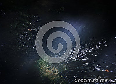 Close up sunbeam falling into running creek concept photo Stock Photo