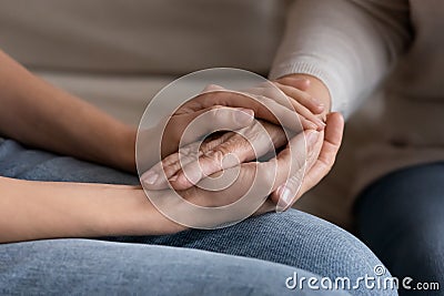 Supportive adult daughter hold senior mom hands Stock Photo