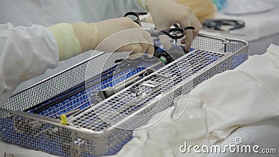 surgical assistant close surgeon prepares endoscopic sterilization instruments