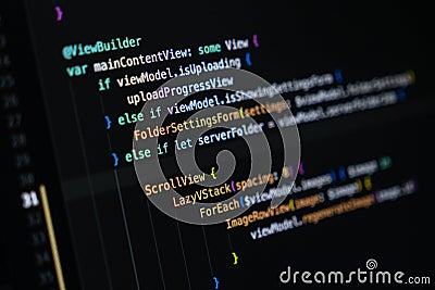 Close-up of Swift programming code on a computer screen showing mobile app interface structure Stock Photo