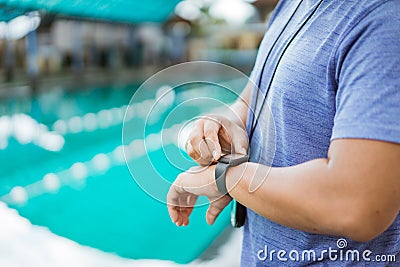 close up of a swimming coach& x27;s hand holding a watch Stock Photo