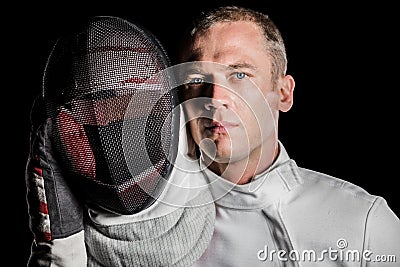 Close-up of swordsman holding fencing mask Stock Photo